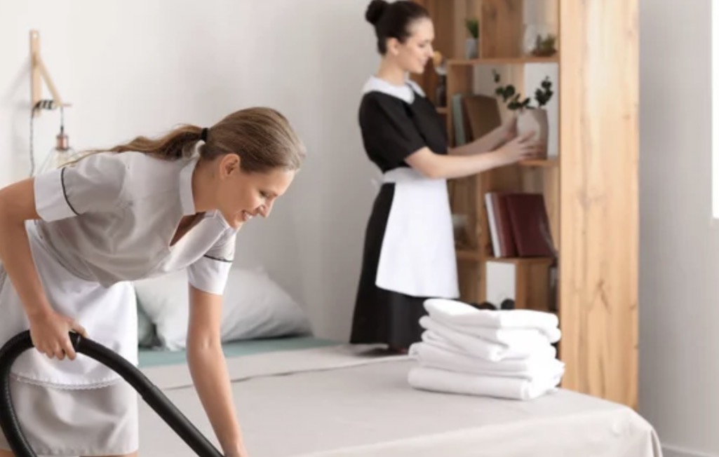 Housekeeping staff cleaning hotel room