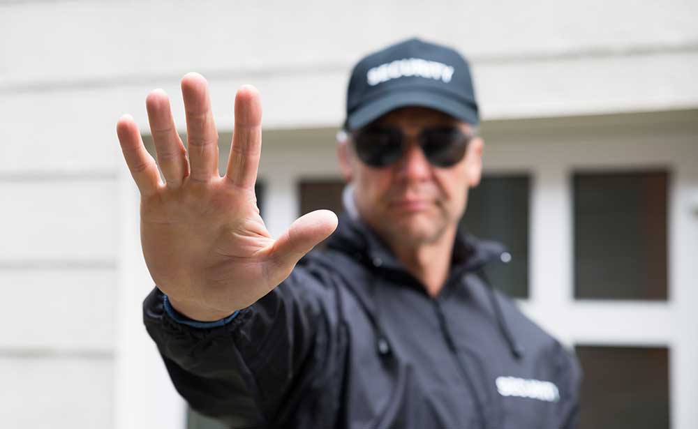 Security officer controlling access at residential entrance